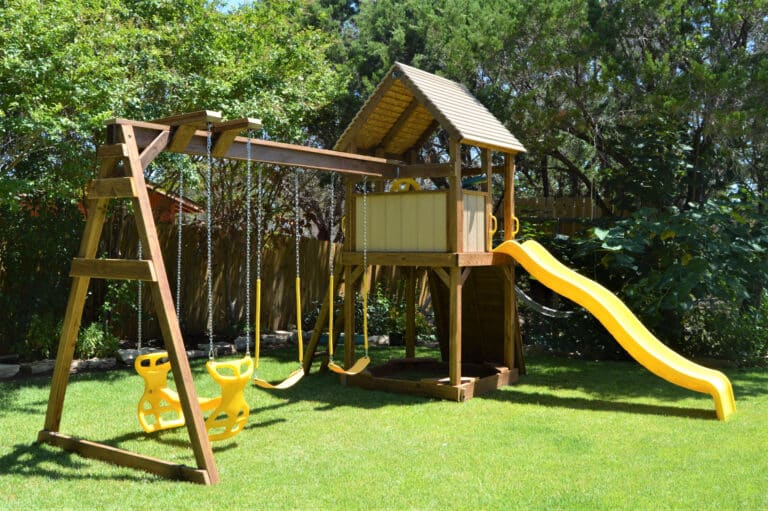 wooden playset with a yellow slide