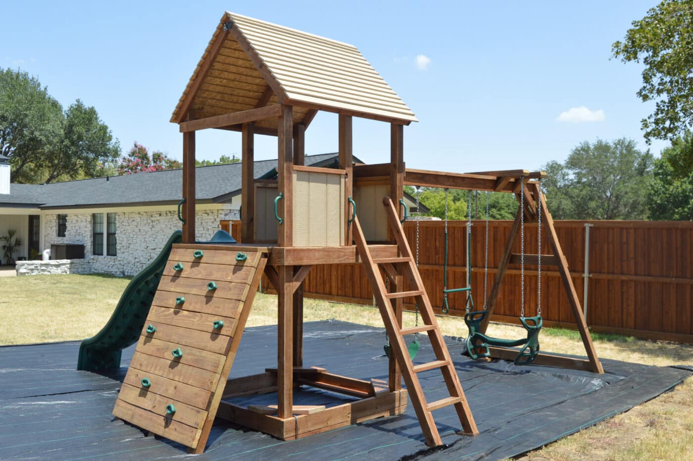simple swing set with rock wall