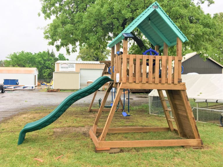 green and blue backyard wooden play set